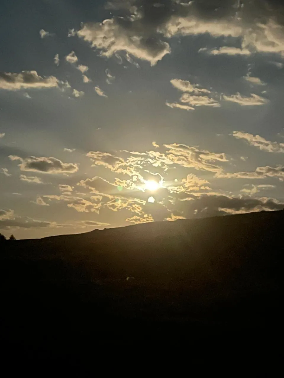 Last light on a Mongolian ridge line, the steppe rolling away into dusk.